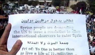 An image grab from footage uploaded on YouTube shows a Syrian anti-government protester holding up a sign calling for UN intervention in Syria during a protest in the central flashpoint city of Homs on September 2, 2011 to stop the regime's bloody crackdown on the opposition