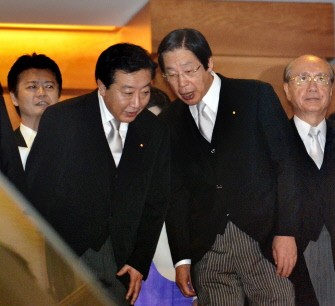 New Japanese Prime Minister Yoshihiko Noda (L) listens to Agriculture Minister Michihiko Kano (R) as they head to a photo session at the prime minister's official residence in Tokyo after their first cabinet meeting on September 2, 2011.