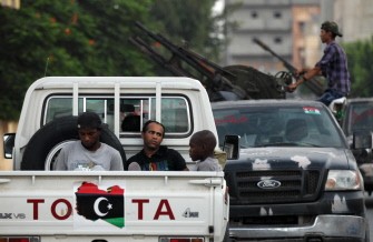 National Transitional Council (NTC) fighters guard prisoners suspected of belonging to a Khadhafi underground group during a raid in Tripoli's flashpoint Abu Slim neighborhood on September 6, 2011