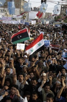 Yemeni anti-government protesters, holding the flags of Syria (front) and Libya's National Transitional Council (NTC), shout slogans against the regime during a demonstration in Sanaa on September 6, 2011