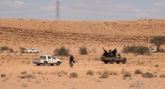 Libya's National Transitional Council (NTC) fighters are seen about one kilometre from outskirts of Bani Walid, southeast of Tripoli, on September 10, 2011