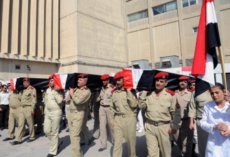 A photo released by the Syrian official news agency (SANA) shows Syrian soldiers carrying the coffins of comrades Ahmed Nizar Awad, Khaled Mohammed Kharsa and Maher Ahmed Habib, at Teshrin military hospital in Damascus on September 10, 2011 after the were allegedly killed in recent violence in the country