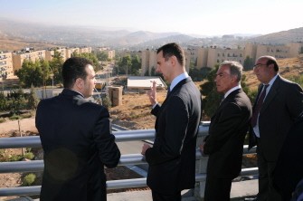 A photo released by the Syrian official news agency (SANA) shows Syrian President Bashar al-Assad (C) speaks to officials and project managers as he is shown the final stages of a road project linking the northern city with the southern city ring road around Damascus, on September 12, 2011