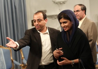An Iranian official directs Pakistani Foreign Minister Hina Rabbani Khar (C) to her seat during a meeting with Iranian President Mahmoud Ahmadinejad in Tehran on September 12, 2011.