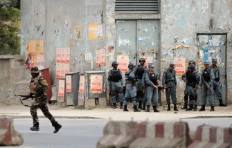 AFP - Afghanistan's security forces stand guard near the building where armed attackers exchanged fire with security forces in Kabul on September 13, 2011.