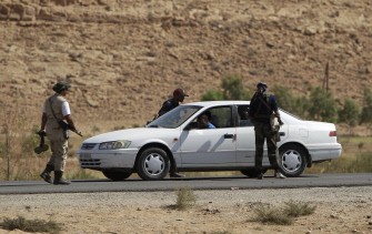 AFP - Libyan National Transitional Council fighters inspect a vehicle of civilians fleeing from the oasis town of Bani Walid, south of the capital Tripoli, on September 13, 2011