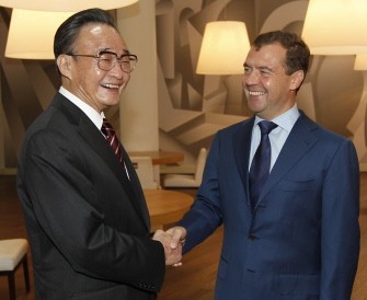 President Dmitry Medvedev (R) shakes hands with China's National People's Congress Standing Committee Chairman, Wu Bangguo (L), as they meet somewhere in an undisclosed location outside Moscow, on September 16, 2011
