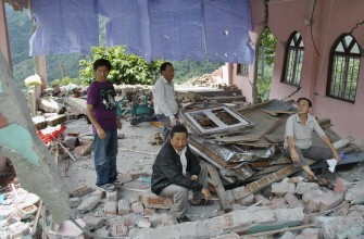 Indian villagers gather in the ruins of a church in Dikchu, some 20kms from Mangan in the north-eastern state of Sikkim on September 20, 2011, after a 6.9 earthquake struck on September 18.