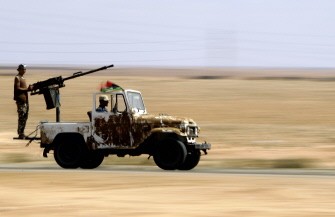 Libyan National Transitional Council (NTC) fighters arrive at the frontline in city of Bani Walid on September 22, 2011