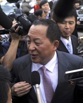 North Korea's chief nuclear envoy Ri Yong-Ho is mobbed by the media as he leaves after a meeting with his South Korean counterpart Wi Sung-Lac in Beijing on September 21, 2011.