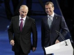 Russia's President Dmitry Medvedev (R) and Prime Minister Vladimir Putin walk along tha stage to address the audience during the United Russia congress in Moscow September 24, 2011