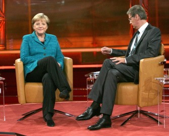 AFP - German Chancellor Angela Merkel sits during the recording of TV host Guenther Jauch's talk show in Berlin on September 25, 2011.