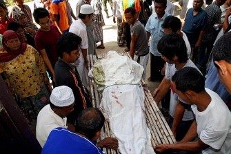 In a file picture taken on June 9, 2009, Thai Muslim villagers remove a victim's body from a mosque in the Cho-i-Rong distrist of Thailand's restive southern province of Narathiwat, a day after gunmen stormed the mosque killing 11 people during evening prayers.