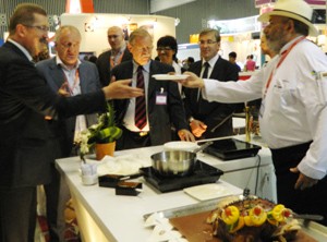 Dr. Robert Kloos (L), Germany’s Vice Minister of Food, Agriculture and Consumer Protection, receives a German dish from the German Pavilion for tasting on September 28, 2011 (Photo: Tuong Thuy)