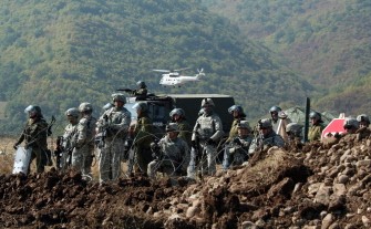 AFP - US Army and German KFOR soldiers guard the border crossing between Serbia and northern Kosovo in Jarinje on September 27, 2011.