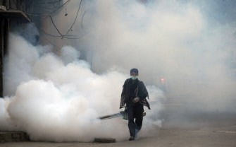 In this photograph taken on September 28, 2011 a Pakistani health worker fumigates against dengue carrying mosquitos in Lahore