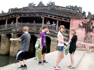 File photo shows foreign tourists visiting what is called the Japanese Bridge in Hoi An Ancient Town (Photo: Tuong Thuy)