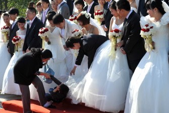 In this picture taken on October 6, 2011 twenty one Chinese couples take part in a group wedding ceremony held at Haidian Park Center in Beijing