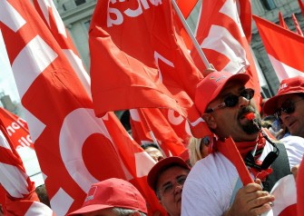Public services employees and students march during the demonstration of general strike organised by the left-wing General Confederation of Italian Workers (CGIL) against the government's economic measures policy in central Rome on October 8, 2011.