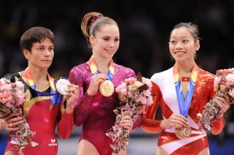 Gold medalist McKayla Maroney of the US (C), silver medalist Oksana Chusovitina of Germany (L) and bronze medalist Phan Thi Ha Thanh of Vietnam (R) pose on the podium during the awards ceremony of the women's vault final at the World Gymnastics Championships in Tokyo on October 15, 2011. AFP