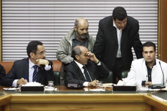 AFP NTC chairman Mustafa Abdel Jalil (C) listens to NTC members during the election that will see Abdel Rahim al-Kib elected as the Prime Minister of the Libyan transitional government October 31, 2011 in Tripoli.