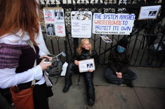 AFP - Supporters of WikiLeaks founder Julian Assange sit on the pavement with signs and banners outside London's High Court on November 2, 2011 where the court was sitting to render a verdict on Assange's legal battle to avoid extradition.