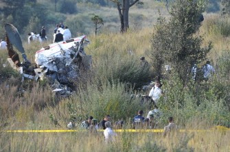 Forensic and technical personnel inspect the debris of the helicopter where the Mexican Interior Sectretary Francisco Blake Mora died on November 11, 2011 in Tlamanalco, Mexico state, Mexico