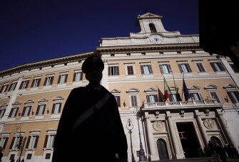 AFP - A carabiniere waits in front of the Italian Lower House in the center of Rome on November 12, 2011.