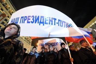 Supporters of Russian Prime Minister Vladimir Putin hold poster reading "Putin - our President!" as thousands celebrate Putin's victory at the presidential election in Moscow March 4, 2012. (AFP Photo)