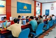 Customers buy tickets at a Vietnam Airlines ticketing office