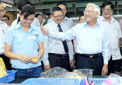 City's Chairman Le Hoang Quan visits workers at a shoes factory of Biti's on April 20, 2012.