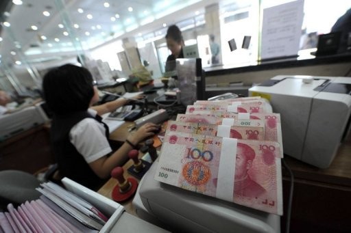 This file photo shows a Chinese bank worker attends to a customer in Hefei, east China's Anhui, in 2010.