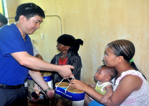 Medical workers supply dairy products to a patient as they believe that people being affected by this strange skin disease suffer from acute malnutrition.