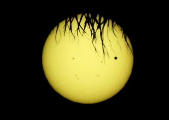 The planet Venus (black spot on the right) in its transit across the face of the sun is seen from Los Angeles, California on June 05, 2012.