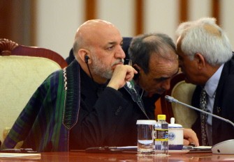 Afghanistan President Hamid Karzai (L) sits with his delegation during the closing session of the Shanghai Cooperation Organization (SCO) summit in the Great Hall of the People in Beijing on June 7, 2012.