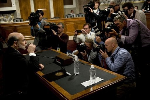 Federal Reserve Chairman Ben Bernanke waits to testify before lawmakers about his economic outlook.