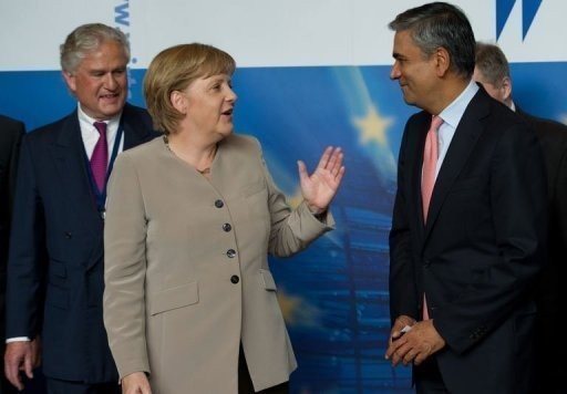 Germany's Chancellor Angela Merkel talks to Deutsche Bank co-chairman Anshu Jain (right) at a meeting of Germany's conservative Christian Democratic Union party in Berlin, June 12.
