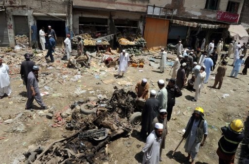 Pakistani security officials inspect the site of a bomb explosion in the main bazaar of Landi Kotal in Khyber tribal district
