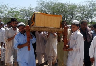 Pakistani relatives carry a coffin of a policeman who was killed in overnight bomb explosion during a funeral ceremony in the northwestern city of Kohat on June 17, 2012.