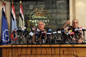 Egyptian General Mamduh Shahin (R) and General Mohammed al-Asaar members of the Supreme council of armed forces hold a press conference to respond to criticisms after the military dissolved parliament and took over legislative power with a new interim constitution in Cairo on June 18, 2012.