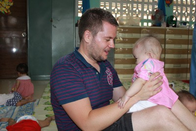 Dan Winthorpe with an unfortunate disadvantaged child in the Sponsor Center for Foster Children in Go Vap District in HCMC.