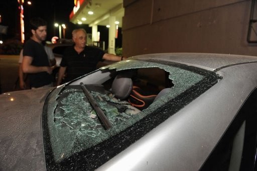 A man stands next to his car, damaged by bullets, allegedly shot from the Palestinian Gaza Strip towards Yad Mordechay in southern Israel.