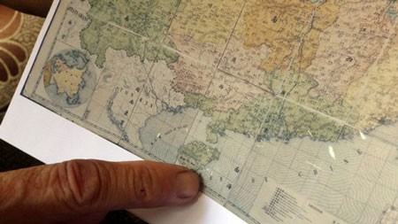 Dr. Mai Ngoc Hong points at Hainan Island in a 1904 Chinese map, which notes the island as China’s southernmost tip.