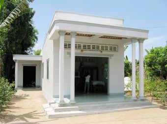 Kim Thi Sa Thia in Cang Long District are happy with her new house which was built thanks to the local government's support