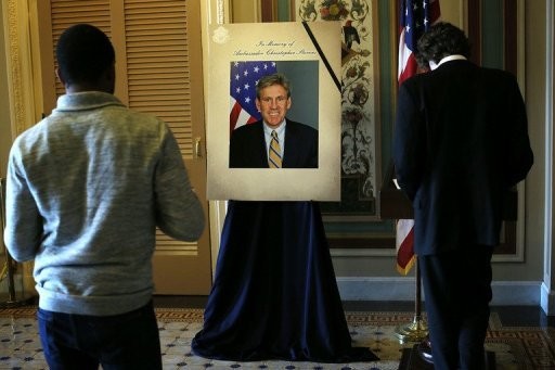 People sign a condolence book for Ambassador J. Christopher Stevens at the US Capitol September 14, 2012 in Washington, DC