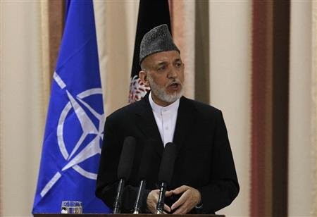 Afghan President Hamid Karzai speaks during a joint news conference with NATO Secretary General Anders Fogh Rasmussen following a security handover ceremony at a military academy outside Kabul on June 18, 2013.