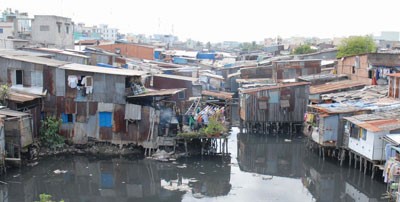 Illegal houses built over canals block water current in HCMC (Photo: SGGP)