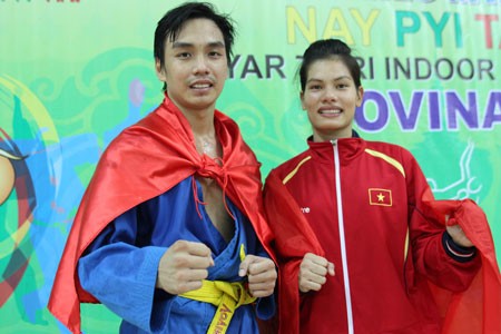 Ho Minh Tam (left) and Nguyen Thi Kim Hoang earn two gold medals for Vietnamese Vovinam team. (Photo: SGGP)