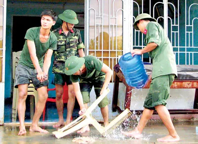 Giúp dân gột rửa bùn trên vật dụng gia đình.