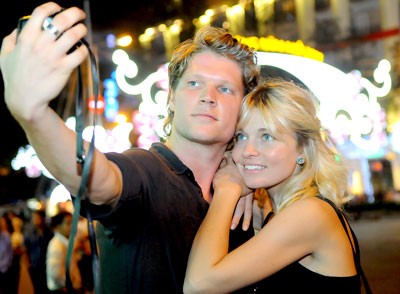 Foreign visitors take photographs on Le Loi Street in District 1.